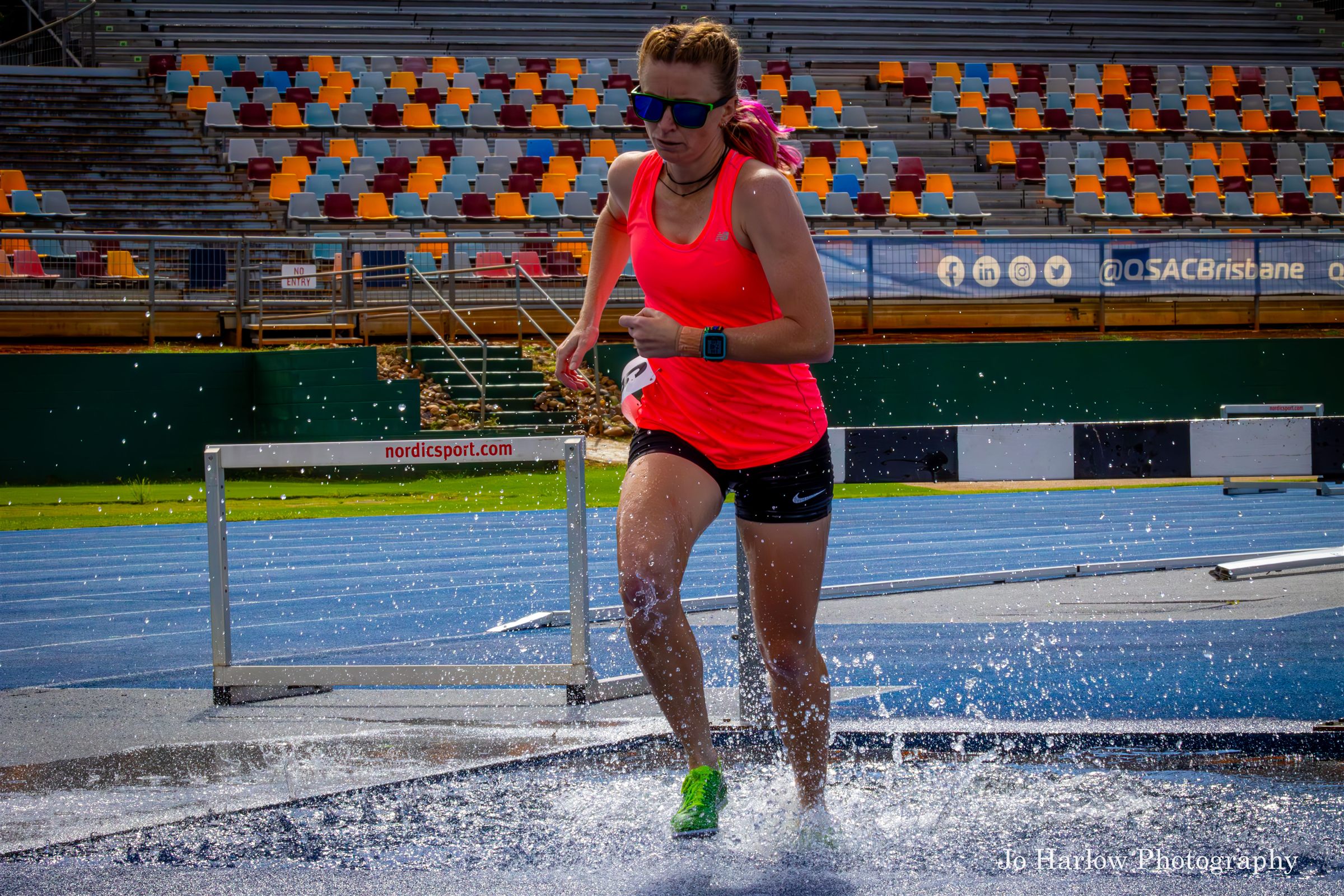 Athlete in the steeplechase water jump