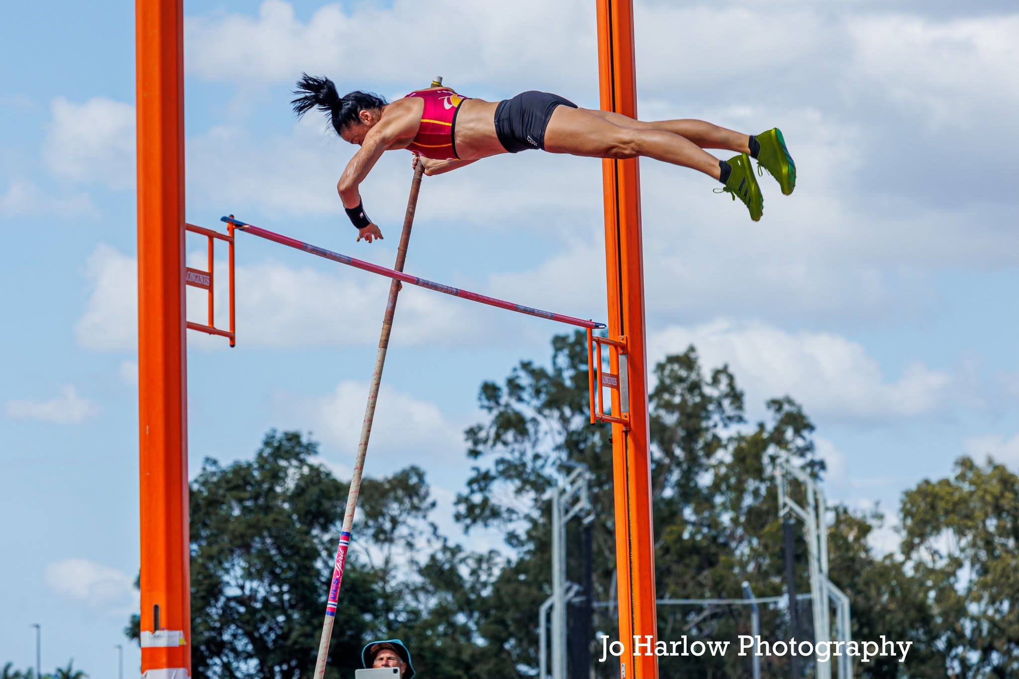 Masters athlete clearing the bar in the pole vault