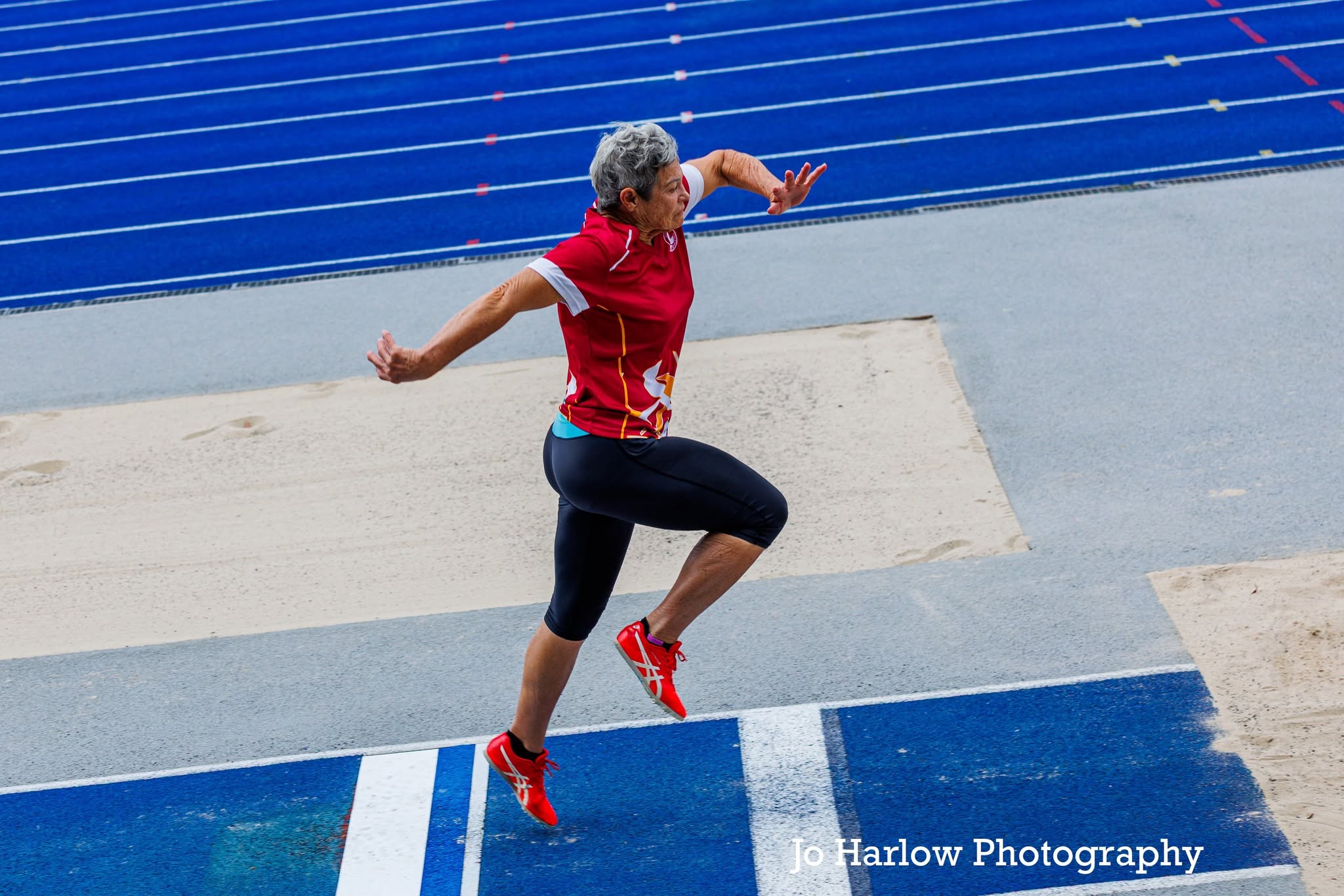 Masters athlete mid-phase in the triple jump
